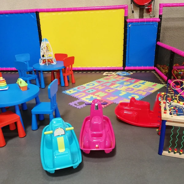 Smooth grey flooring in a vibrant children's indoor play area