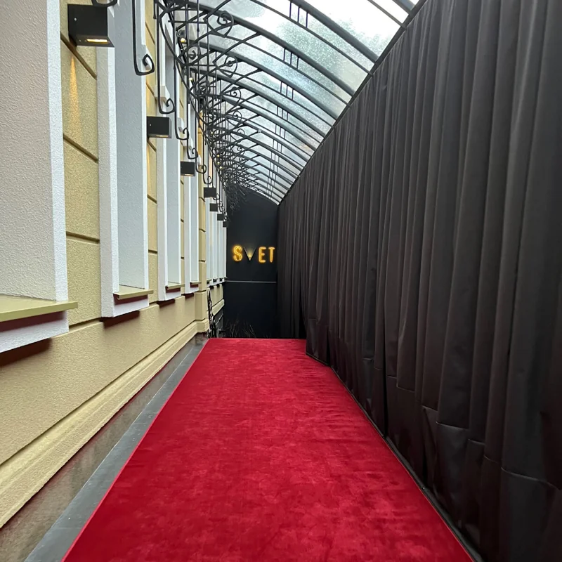 Red event carpet runner in a banquet hall.
