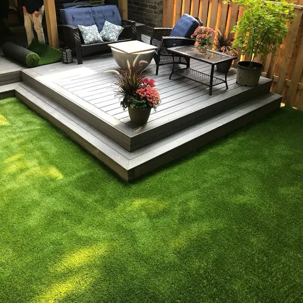 Residential backyard featuring durable artificial grass carpet and composite decking.
