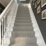 Ribbed grey stair runner on dark wood steps