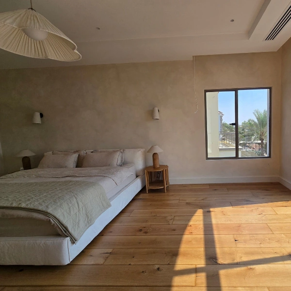 Rustic long-plank wood flooring with warm golden tones