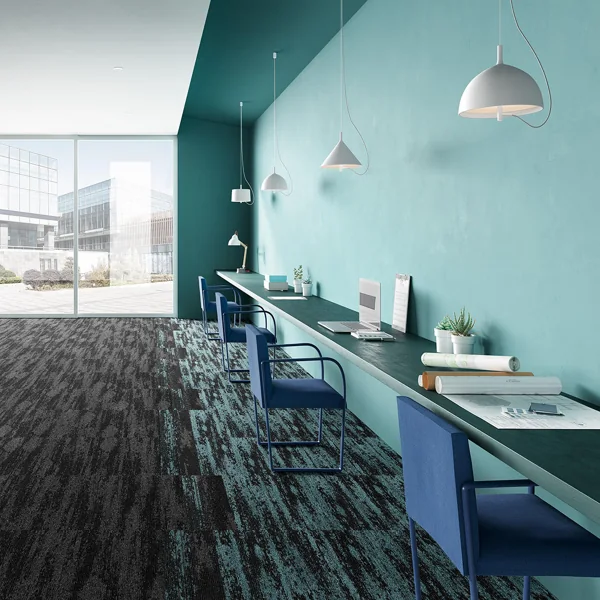 Textured black and blue carpet tiles in a modern office workstation.
