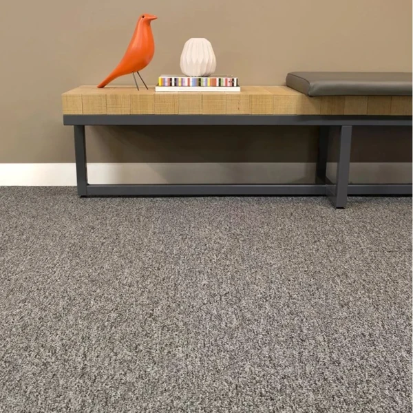 Textured grey wall to wall carpet under bench