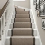 Top-down view of beige stair carpet and landing