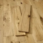 Two planks of natural oak flooring on a floor.