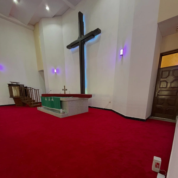 Vibrant red carpet covering the floor of a modern church sanctuary