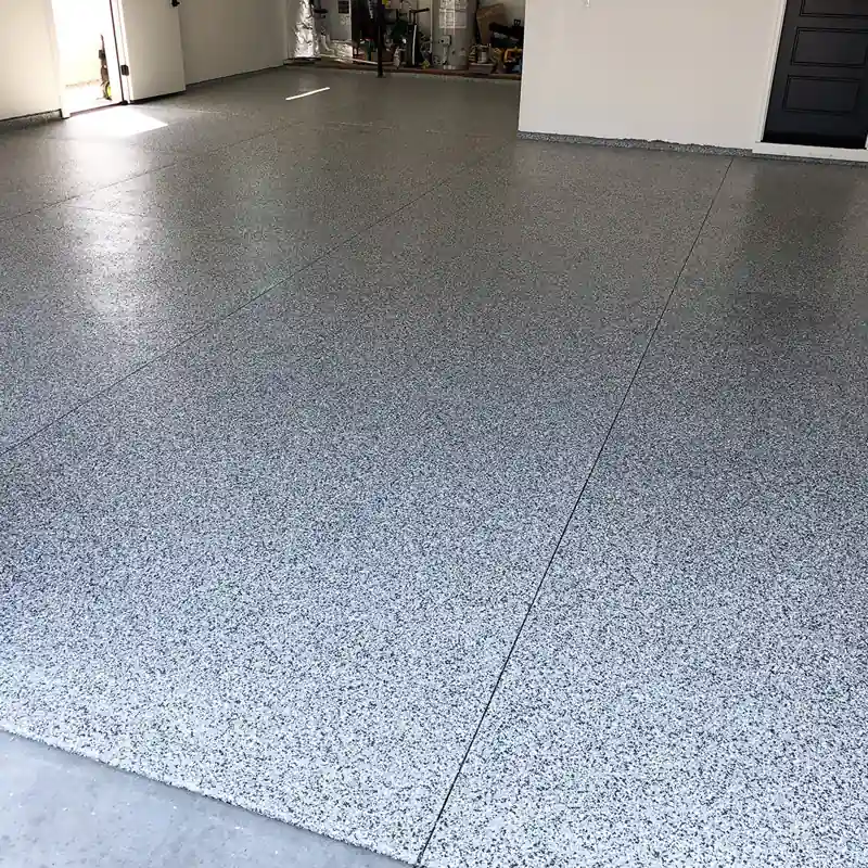 smooth, gray speckled epoxy garage floor finish is shown.