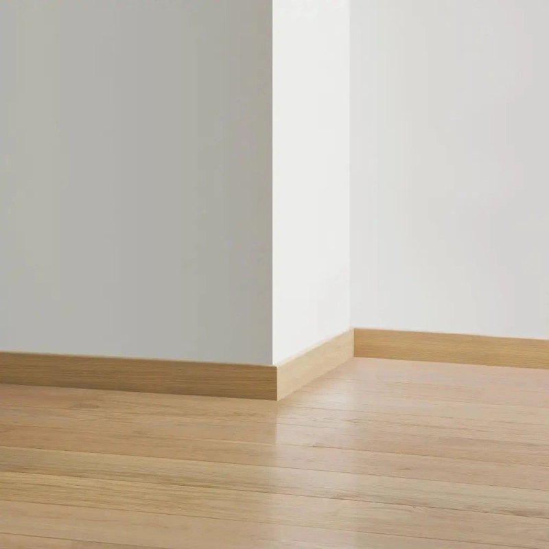 Contoured pine skirting on wood look flooring