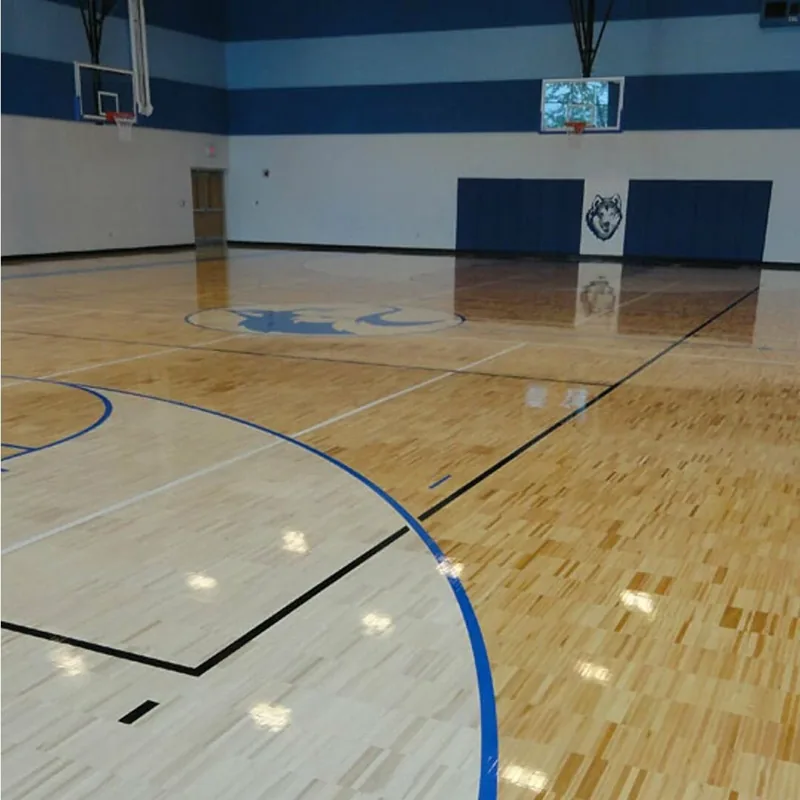 Indoor basketball court featuring polished wooden sports flooring