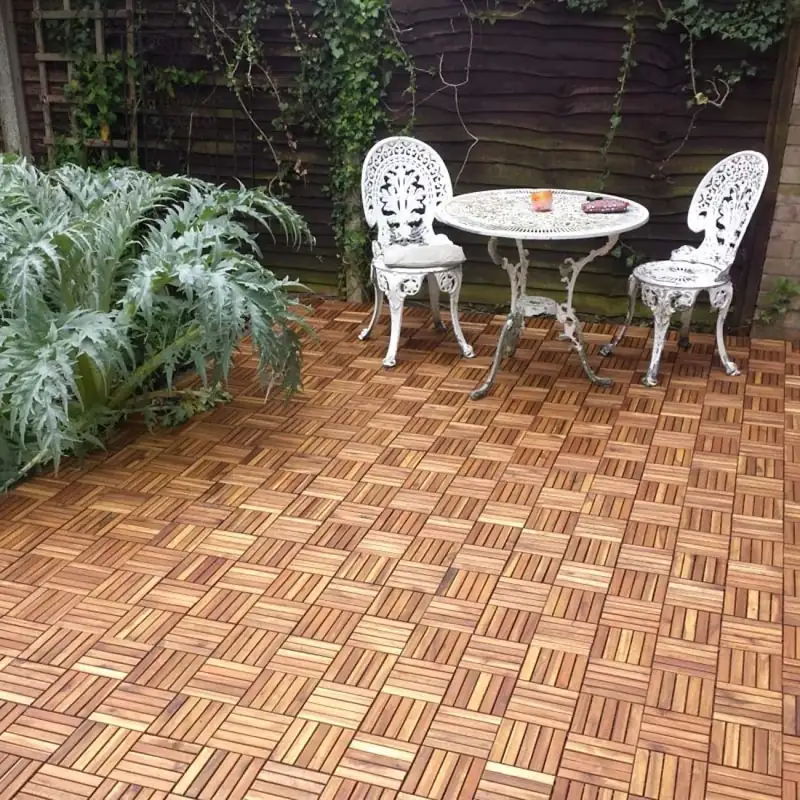Light wood interlocking deck tiles by a luxury pool area