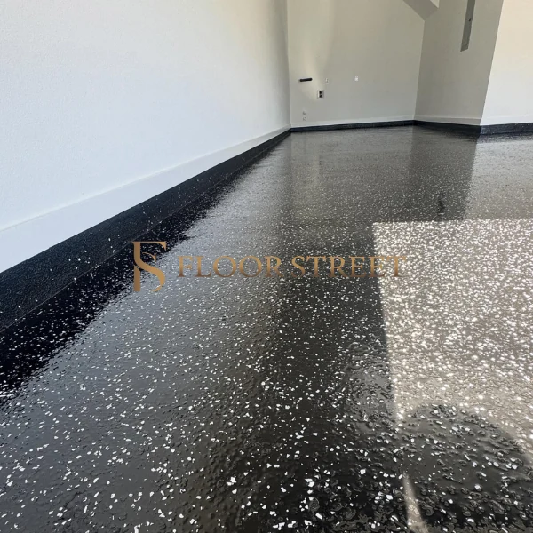Polished black epoxy flooring with flake texture.