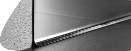 Polished silver metal skirting board profile view