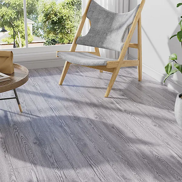 Grey wood-look SPC flooring planks under a modern accent chair