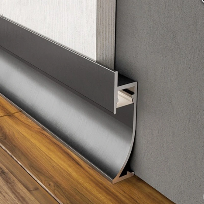 Silver aluminum baseboard corner on dark tiled floor