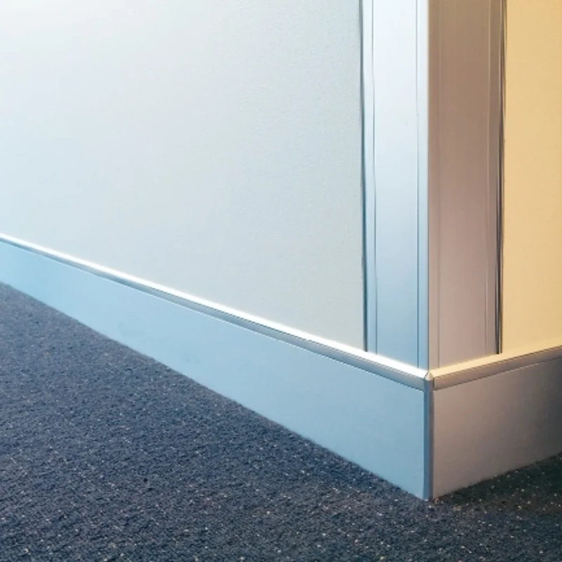 Silver aluminum skirting corner on blue carpet