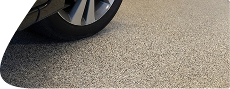 Spacious garage with black speckled epoxy floor coating