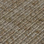 Top-down view of tan and brown woven jute rug texture