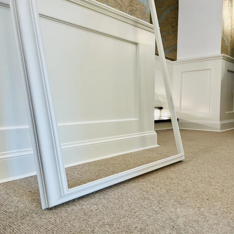 White Victorian MDF skirting board on beige carpet