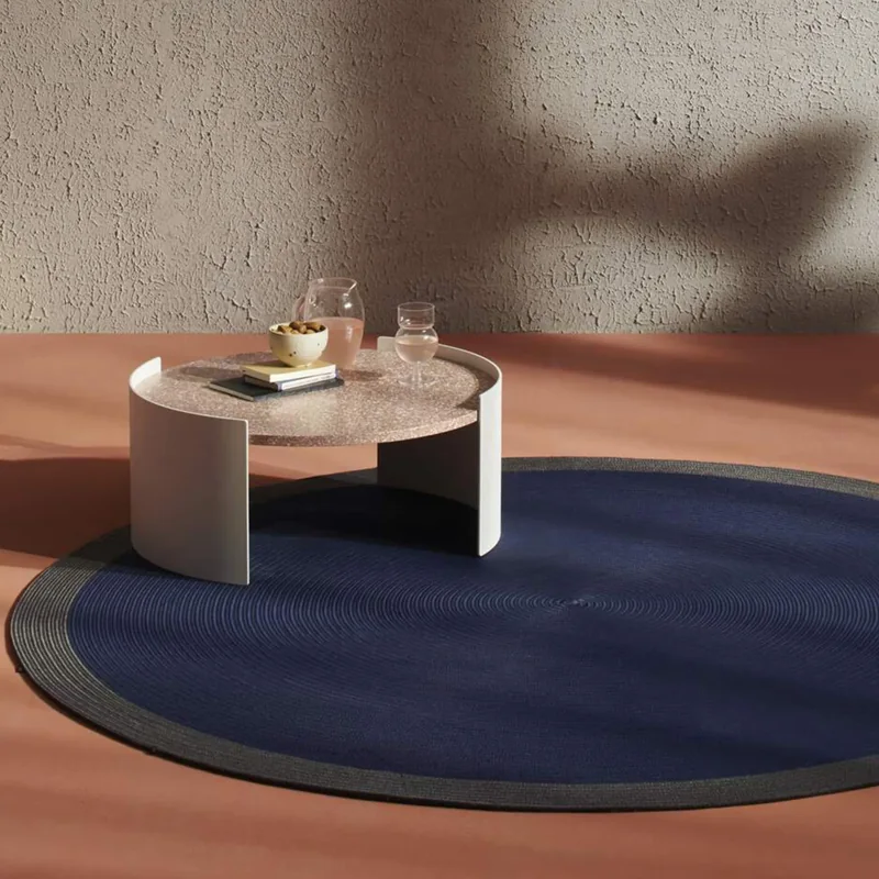 dark blue round carpet with a grey border