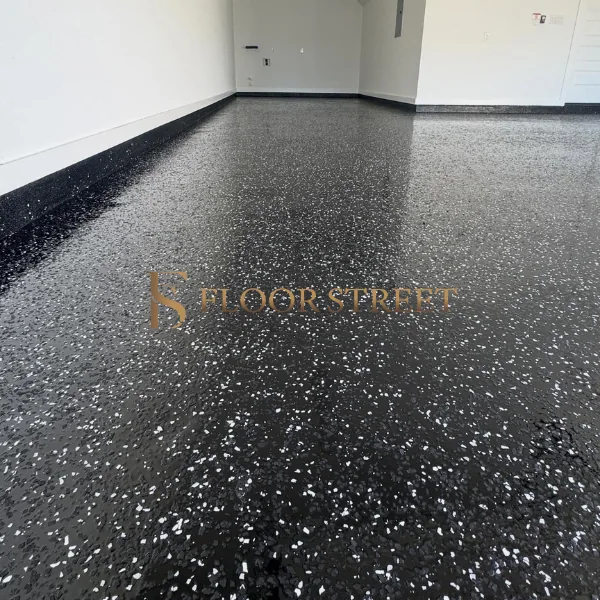 epoxy garage floor with white and grey decorative flakes.