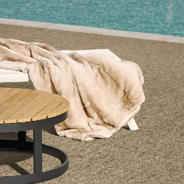 textured beige outdoor carpet near a poolside