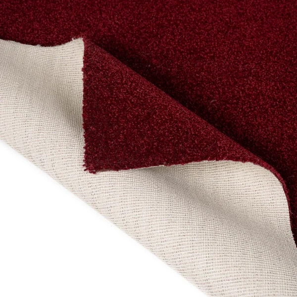 Red carpet swatch showing woven felt backing